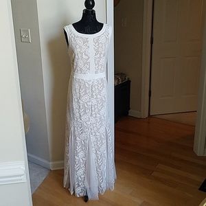 Long length tan dress with a white lace overlay.